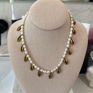 brinker and Eliza necklace with pearls and gold plated conch shell charms
